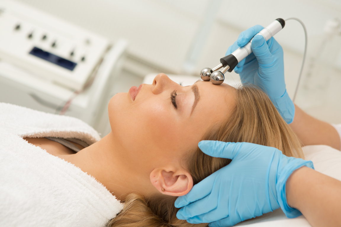 Beautiful woman getting microcurrent facial treatment